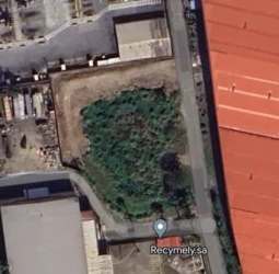 Aerial of fenced industrial land adjacent port Manzanillo Colón with access roads and warehouses