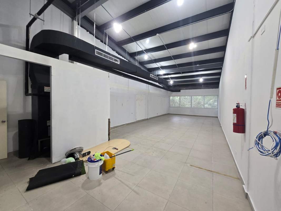 Empty industrial-style commercial unit interior with tiled floor at Plaza 770 Costa del Este