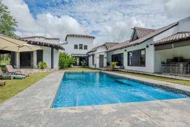 Dining area with exposed beams, wooden furniture and contemporary rustic style inside luxury estate Coclé Panama