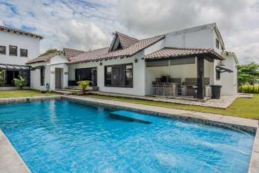 Luxury countryside mansion with wide terraces, tiled roof, palm landscaping in El Nido Coclé Panama