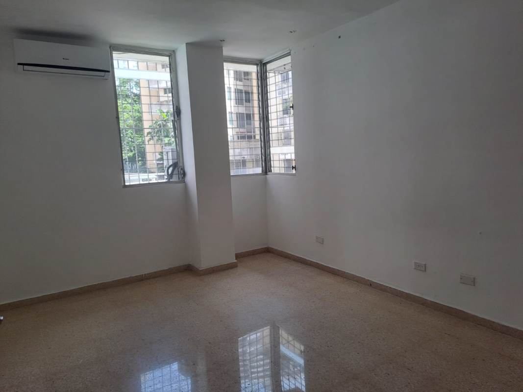 Living space with open plan, air conditioning, large barred windows at PH El Carmen Towers Panama