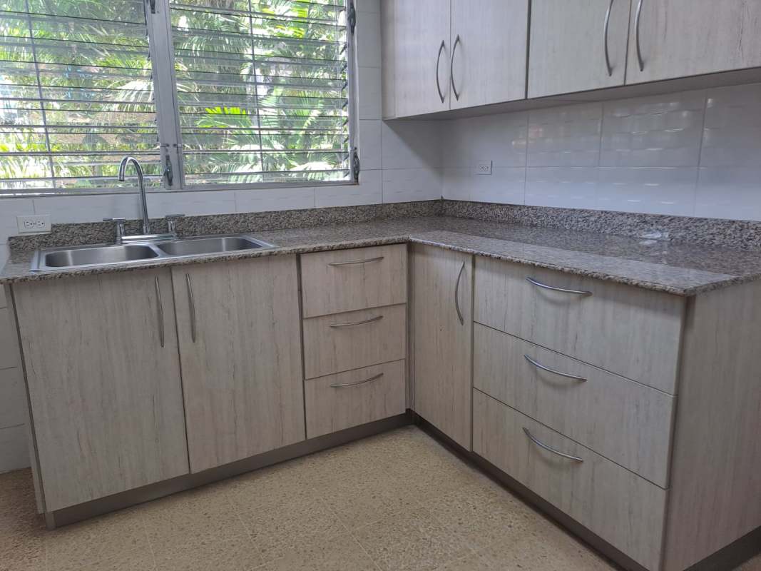 Modern kitchen with granite countertops, double sink, and light cabinets in PH El Carmen Towers Panama