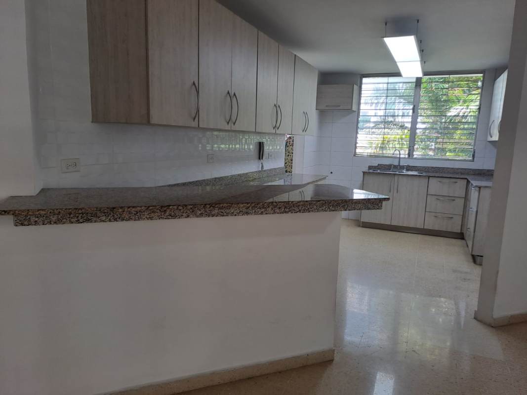 Granite countertop kitchen with window light and storage cabinets in PH El Carmen Towers Panama City