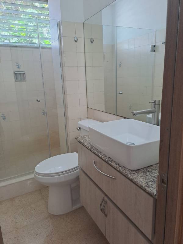 Modern bedroom with light wood closet and tiled floors PH El Carmen Towers Panama City