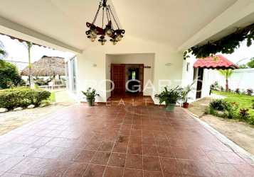 Modern kitchen with white cabinetry and large window in beachfront villa Panama