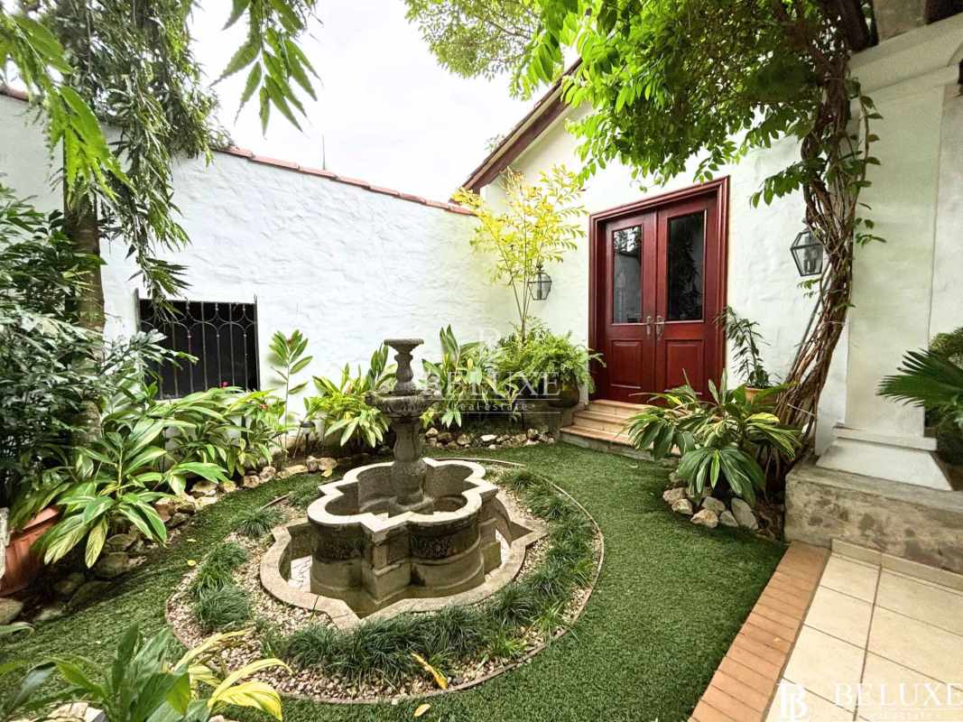 Spacious covered terrace overlooking tropical garden and pool at luxury house Panama