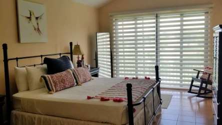 Bright bedroom with garden view, modern furniture in luxury Buenaventura beach villa Panama