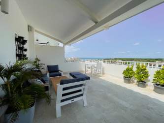 Spacious terrace with seating dining and ocean view at Puntarena Buenaventura