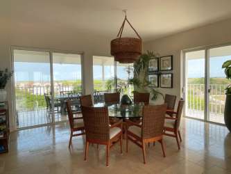 Bright dining area with large windows overlooking balcony at Puntarena Buenaventura Panama