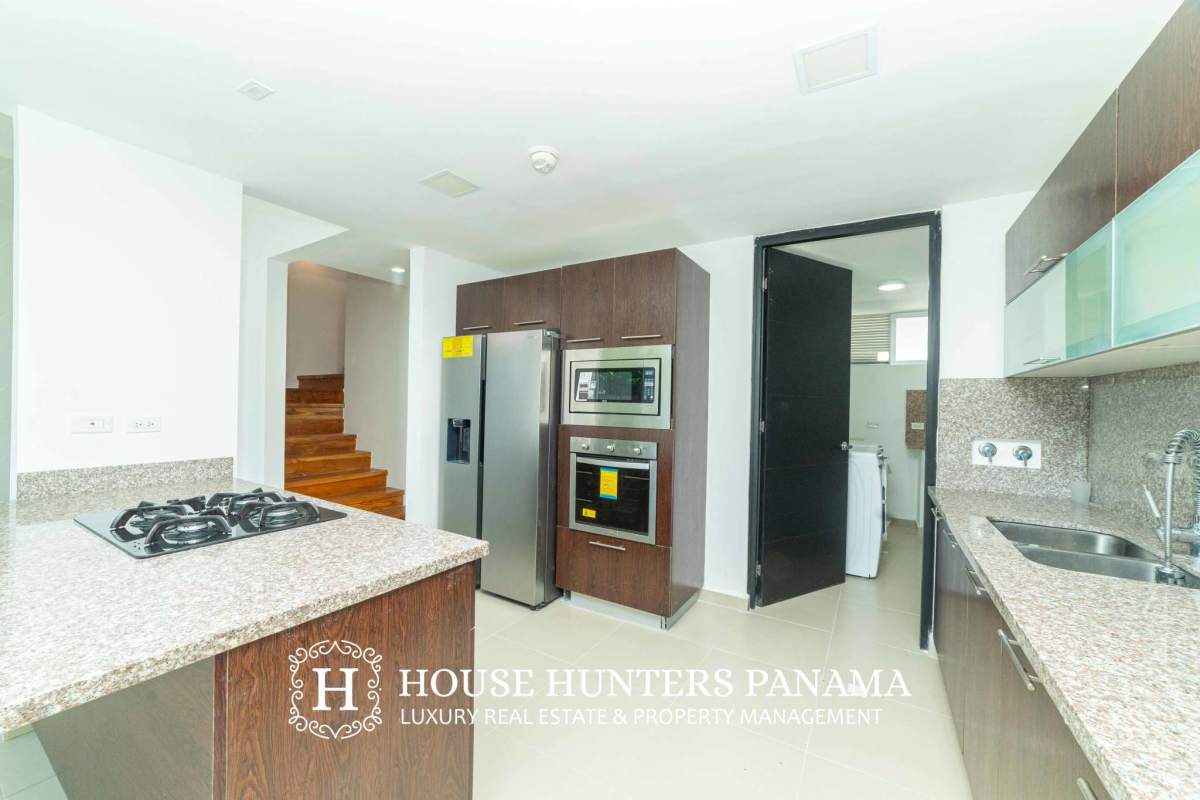 Bright open living area with tile floors and terrace access in Costa Sur Village Panama