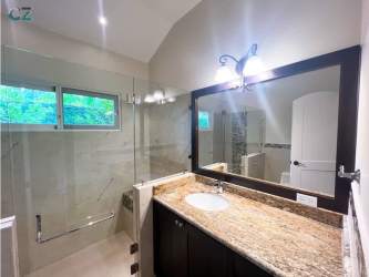 Bathroom with glass shower granite countertops Azura home Panama