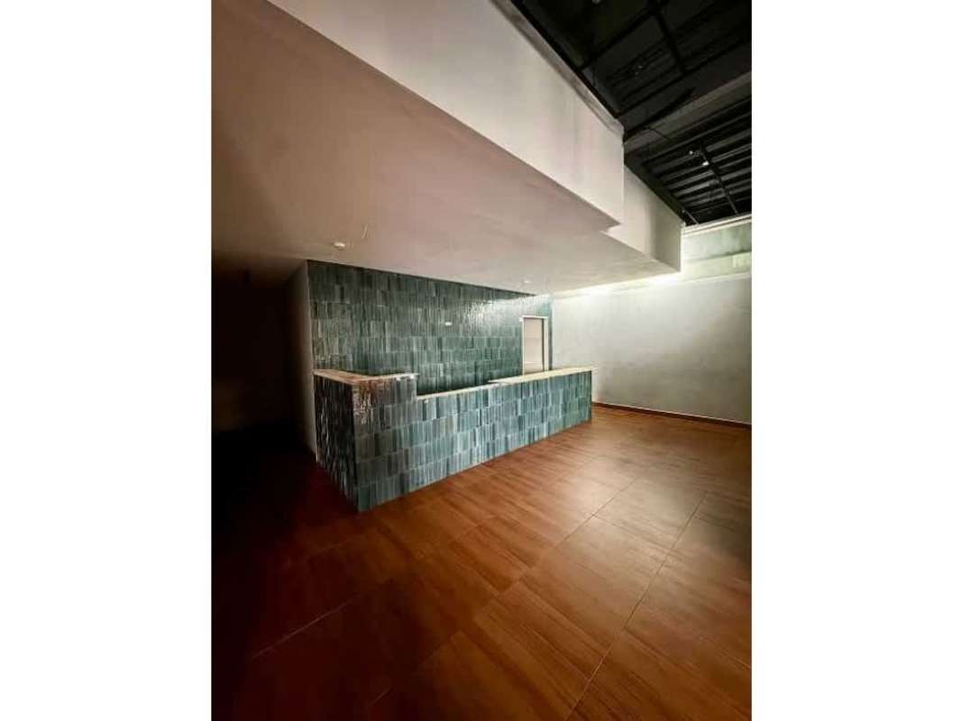 Modern industrial finished blue-green tile bar counter and open floor plan commercial space in Plaza Corne 68 San Francisco Panama