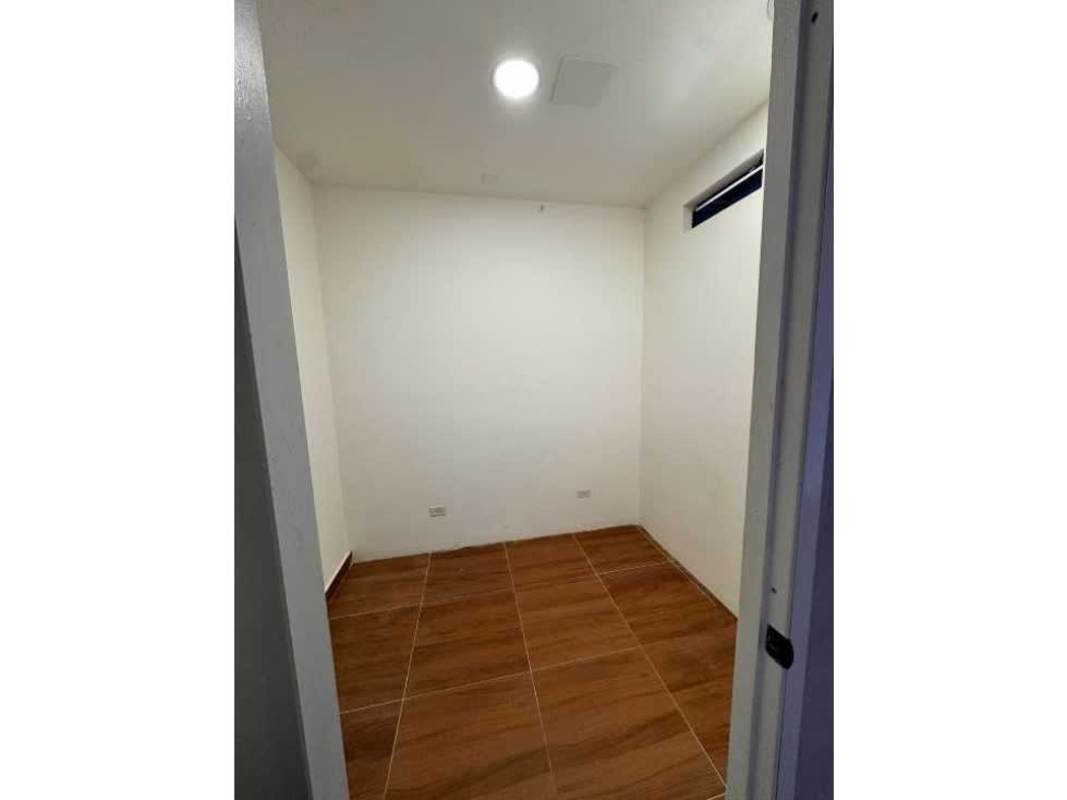 Compact room with white walls, narrow window and ceramic floor inside commercial Plaza Corne 68 Panama