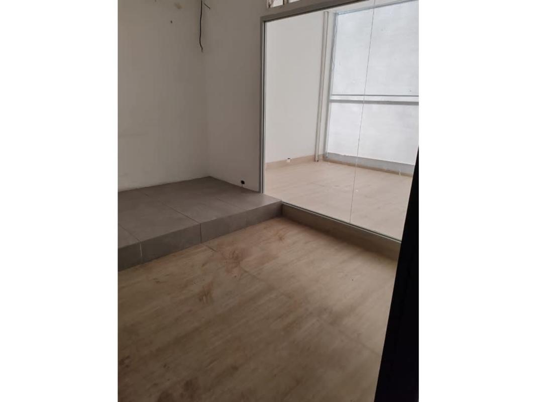 Interior with wood-look floor, elevated platform, glass door to terrace, Plaza 68 San Francisco Panama