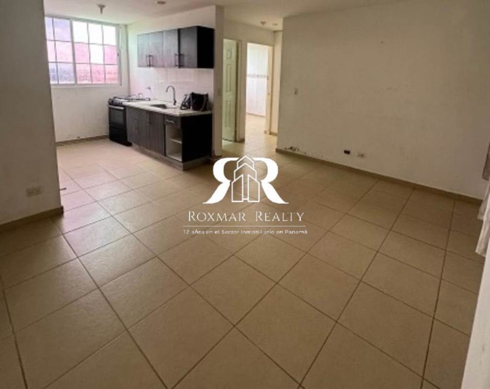Apartment interior with open kitchen and living space with large window Mystic Hills San Miguelito Panama