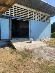 Exterior with open metal doors and loading area of Santiago Business Hub warehouse complex Panama