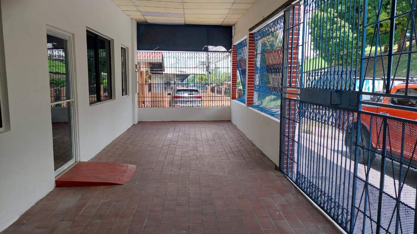 Covered carport area with ramp, security bars and brick flooring at commercial building San Miguelito Panama