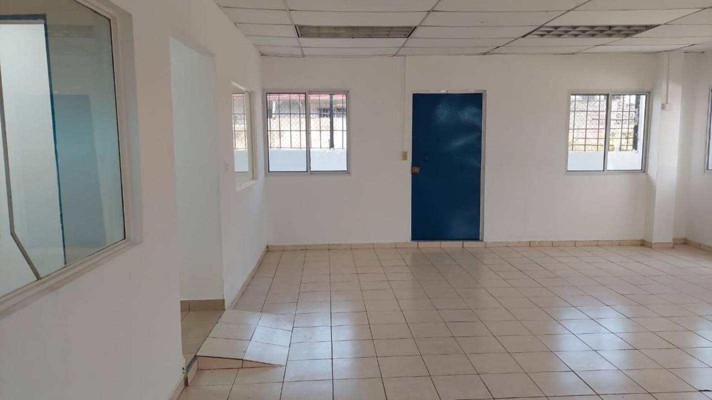 Open tiled workspace with windows and columns inside commercial building San Miguelito Panama