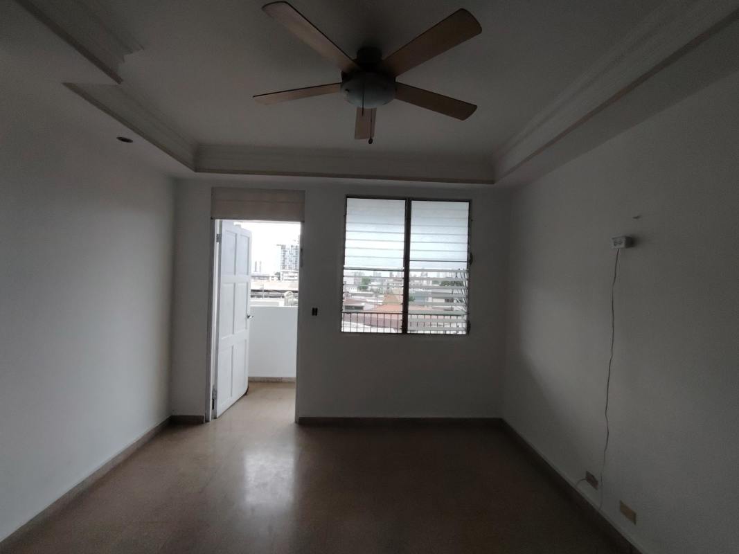 Bedroom with large windows, ceiling fan, view of Panama City in PH Lorelei Parque Lefevre