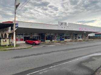 Urban retail plaza with multiple storefronts and sidewalks in David Panama