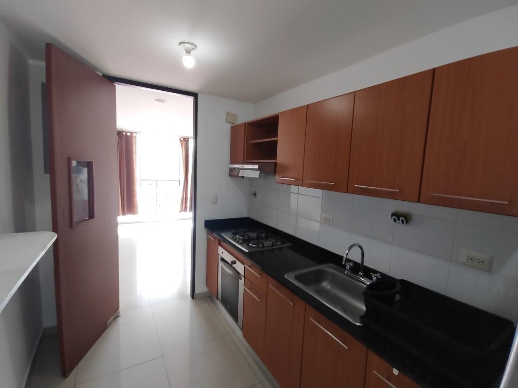 Modern kitchen with granite countertops, wood cabinetry, gas stove, refrigerator in PH Altavista Tower Panama