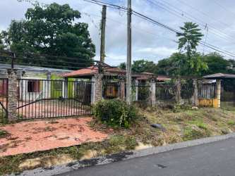 Suburban land lot with single-story structure, iron gate, garden Paso Canoas border Panama