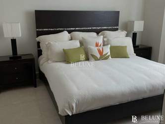 Modern bathroom with glass shower enclosure and vanity at beach condo Bijao