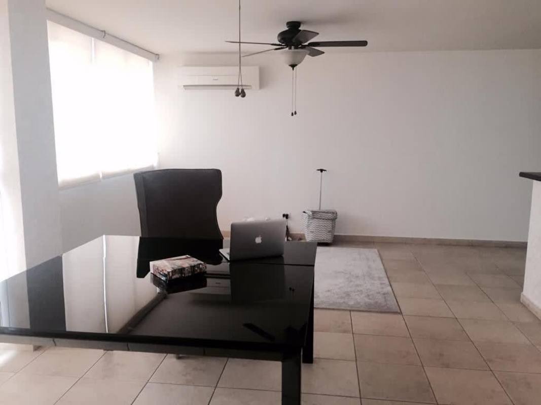 Minimalist modern office with glass desk, chair, fan, tiled floor in PH Rim Tower for rent Panama
