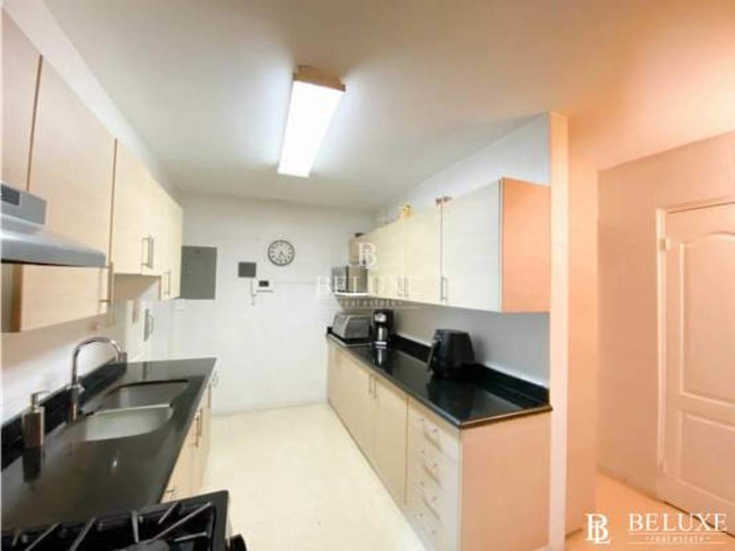 Kitchen with light wood cabinets, black granite countertops, stainless sink Bethania house for sale
