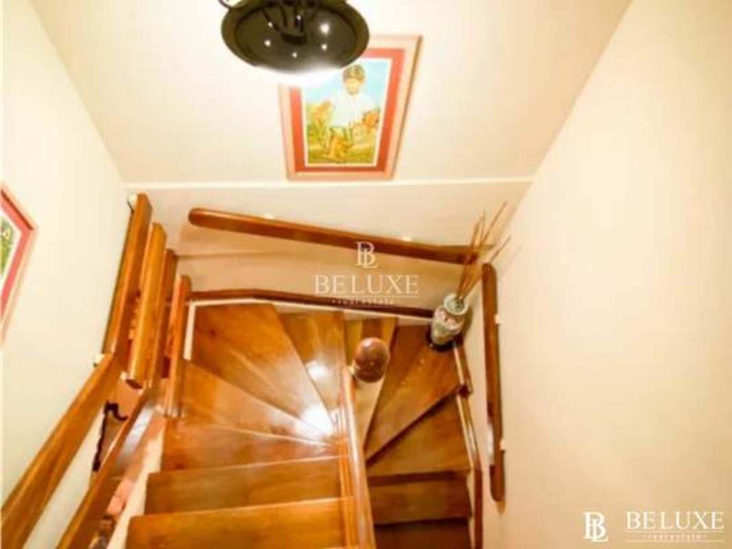 Interior wooden spiral staircase with art decor in Bethania house Panama for sale