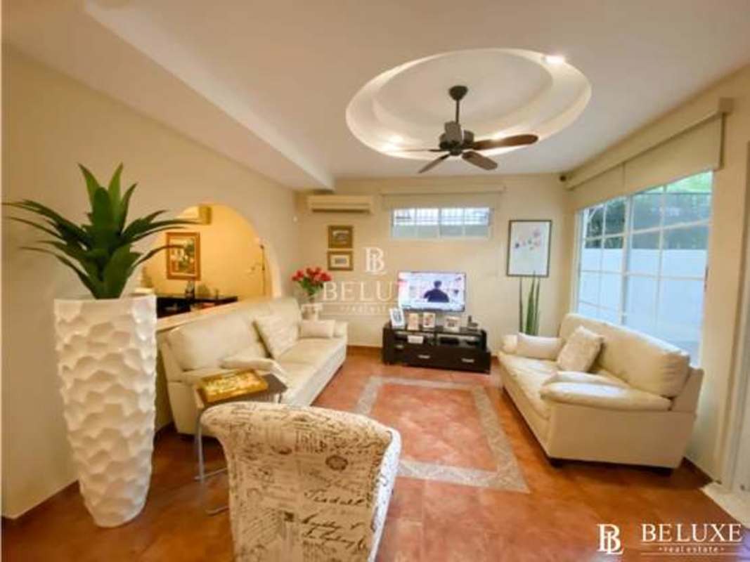 Cream sofas, large windows with garden view, modern design in house for sale Bethania Panama