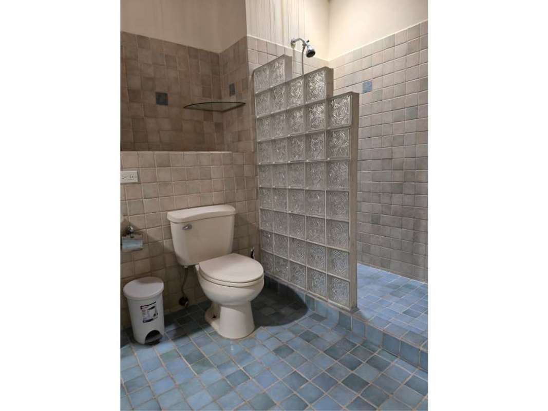 Bathroom featuring glass block divider and blue tiles in PH San Felipe Residences Casco Viejo Panama