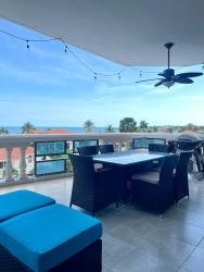 Modern living room with sliding glass doors to ocean balcony in PH Coronado Country Club Panama