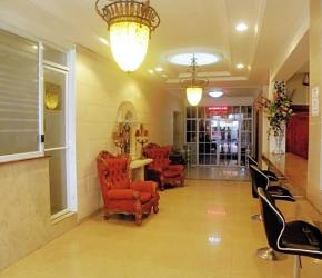 Elegant lobby chandelier red armchairs spacious reception Colon Free Zone Panama hotel for sale