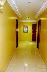 Corridor with crown molding, tile floor and multiple doors hotel for sale Colon Free Zone Panama