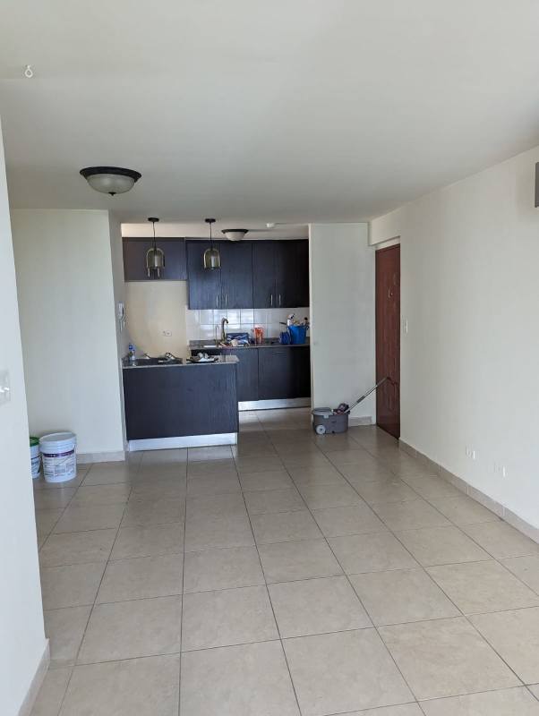 Open concept kitchen and living area empty in PH Splendor By The Park Carrasquilla with tile floors