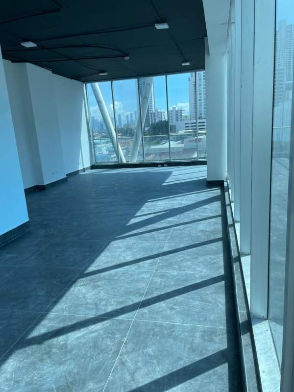 Spacious open office with floor-to-ceiling windows, tile floor providing natural light at PH BICSA Financial Tower