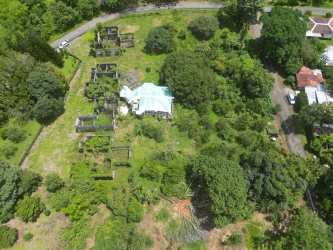 Top view of large plot with central house and lush vegetation near Boquete Highway
