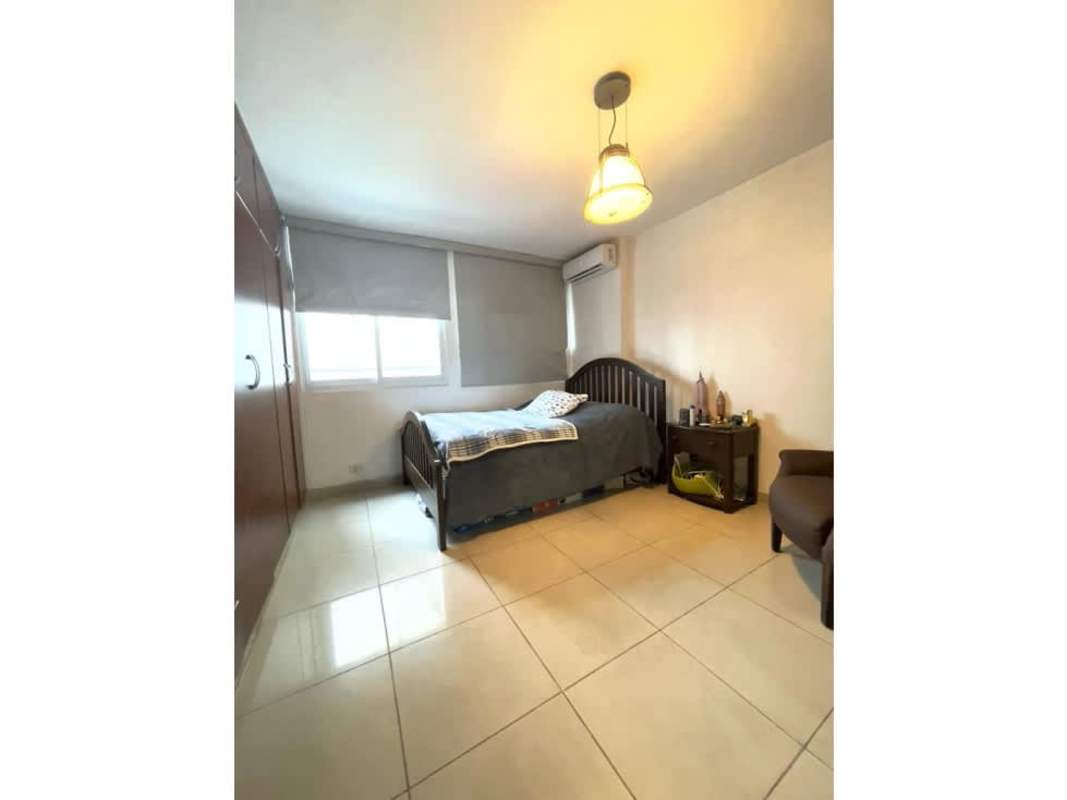 Contemporary kitchen with granite countertops, wood cabinets, and side-by-side fridge at Vista del Sol Punta Paitilla