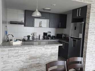 Fully furnished living room with balcony access at PH Ocean II Playa Blanca Panama