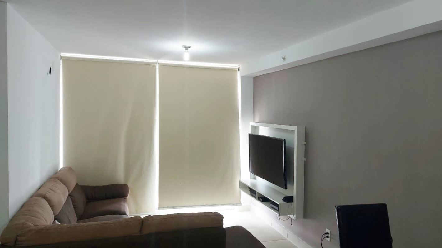 High-rise building exterior with swimming pool and sun loungers in PH Alegria Panama