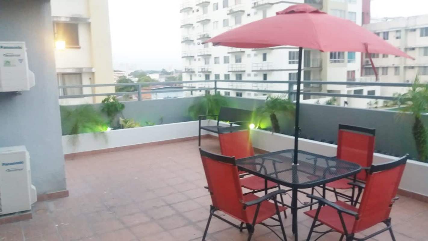 Modern apartment lobby with high ceilings, mezzanine balcony, sofas PH Parque Lindo Panama