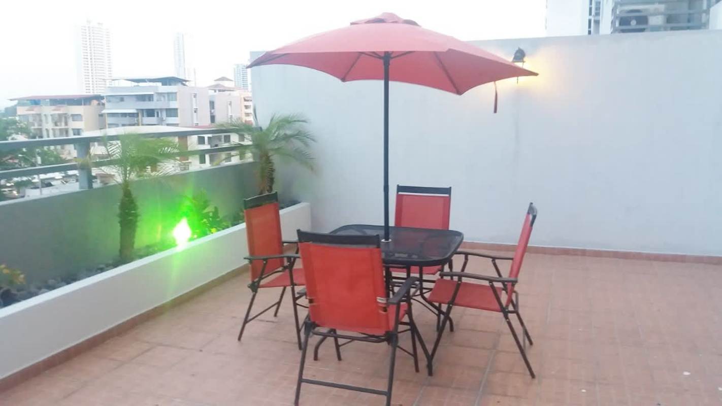 Terrace patio with umbrella, outdoor furniture, planter palm trees PH Parque Lindo Panama