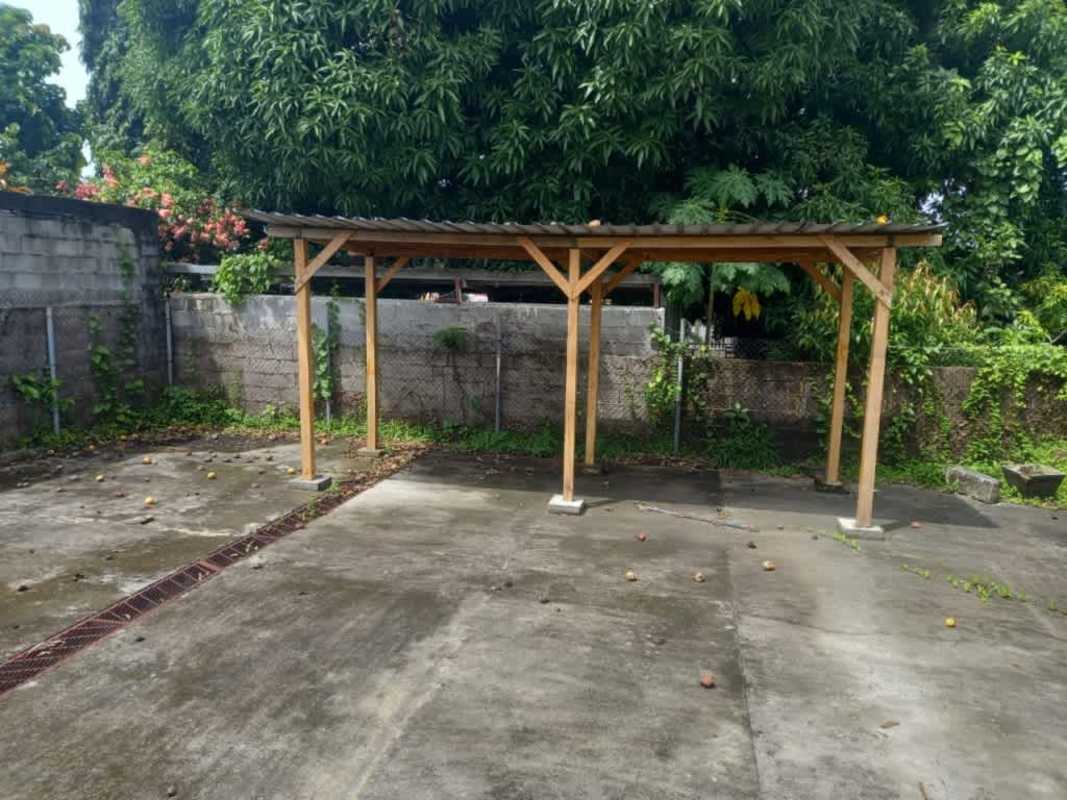 Concrete yard with wooden pergola structure backyard Villa Rica Panama
