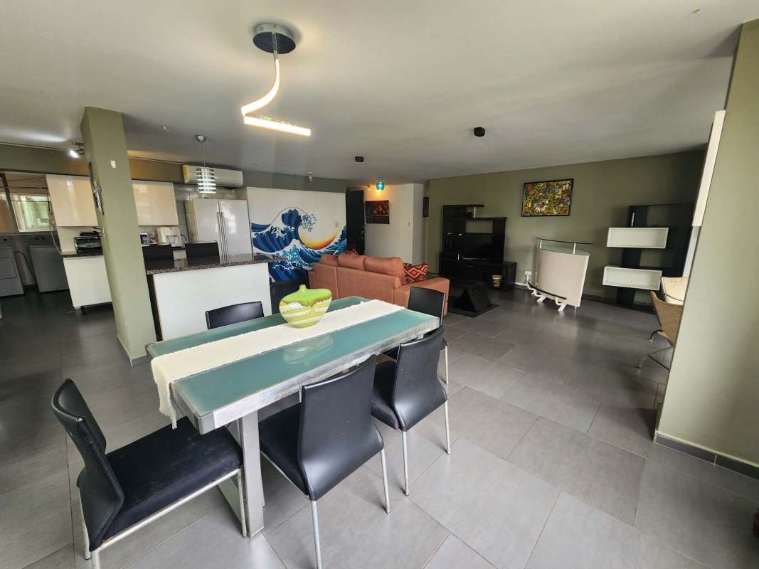 Open kitchen with granite counters, appliances and dining bar in PH Ocean View Punta Paitilla furnished apartment rental.