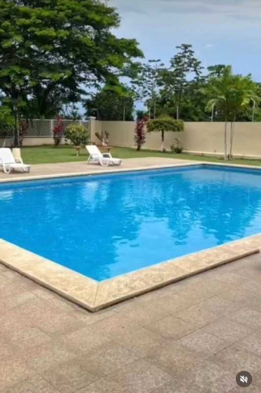 Outdoor tennis court surrounded by palm trees in Brisas del Golf community Panama