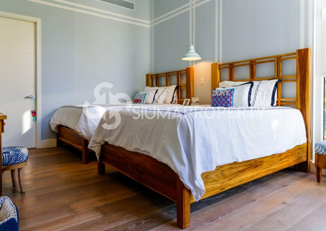 Modern bedroom with balcony and lush green views on Pearl Island Panama