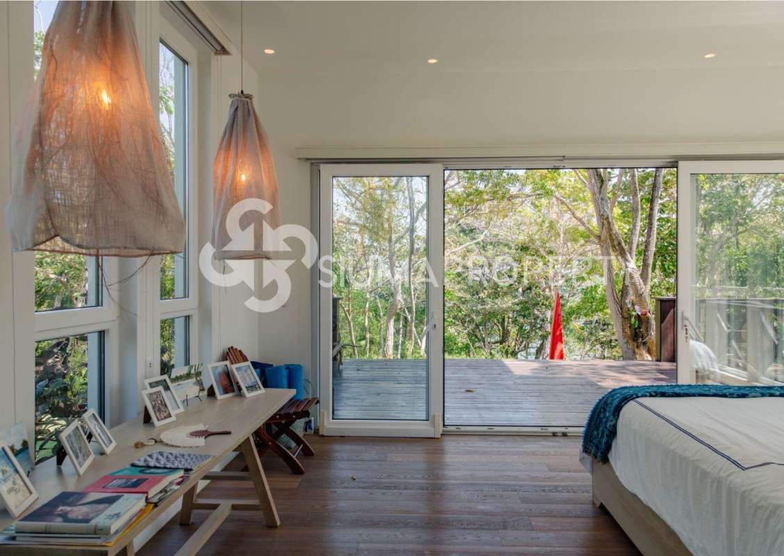 Contemporary bathroom with double sinks, wood accents and stone countertop Pearl Island Panama