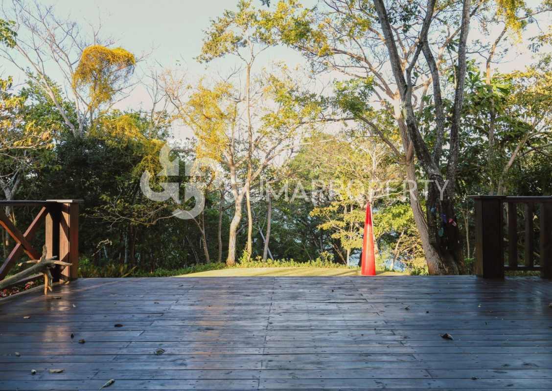 Wooden deck area surrounded by lush greenery perfect for relaxation Pearl Island Panama