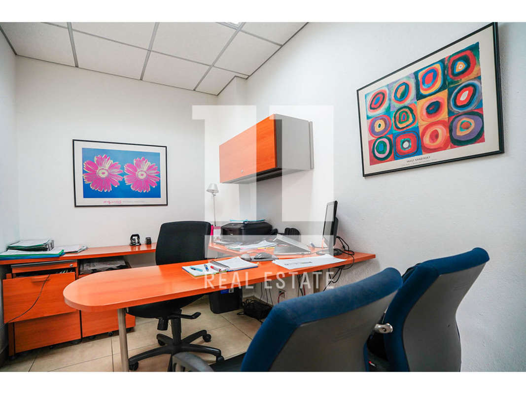 Covered parking garage with column stripes and multiple cars in Obarrio Panama City